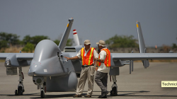 Technicians stand next to a Heron drone to be used in a surveillance demonstration related to El Salvador's anti-drug operations, at the second military air base in Comalapa. (Photo: Luis Romero / AP)